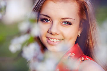 Image showing Girl in the flowers of cherry