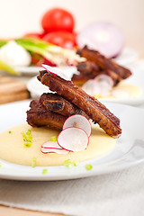 Image showing pork ribs on polenta corn cream bed