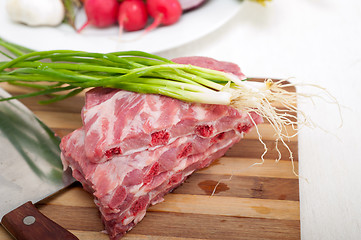 Image showing chopping fresh pork ribs and vegetables