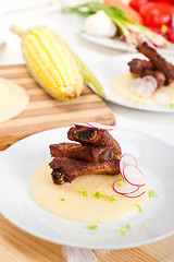 Image showing pork ribs on polenta corn cream bed