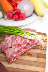 Image showing chopping fresh pork ribs and vegetables