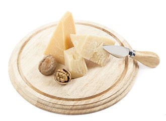 Image showing Nuts and cheese on wooden board.