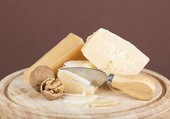 Image showing Nuts and cheese on wooden board.