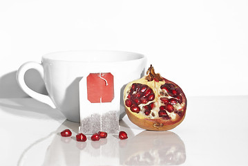 Image showing Juicy pomegranate and tea bag