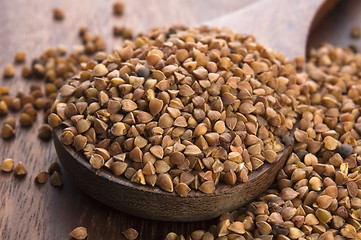 Image showing Buckwheat seeds on wooden spoon in closeup 