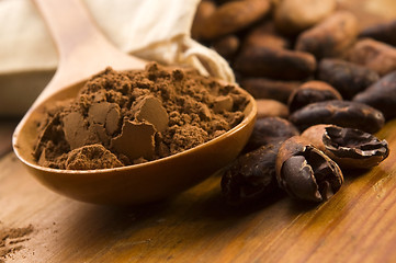 Image showing Cocoa (cacao) beans on natural wooden table