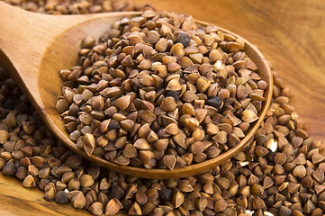 Image showing Buckwheat seeds on wooden spoon in closeup 