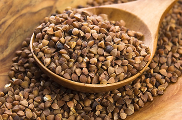 Image showing Buckwheat seeds on wooden spoon in closeup 
