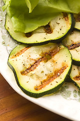 Image showing Grilled organic zucchini slices with herbs and spices