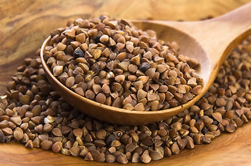 Image showing Buckwheat seeds on wooden spoon in closeup 