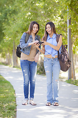 Image showing Young Adult Mixed Race Twin Sisters Sharing Cell Phone Experienc