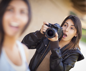 Image showing Excited Female Mixed Race Photographer Spots Celebrity