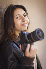 Image showing Mixed Race Young Adult Female Photographer Holding Camera