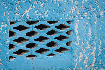 Image showing Blue aged street wall with black brick holes