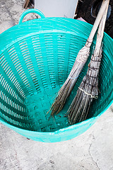 Image showing Old brooms after sweeping keep in plastic basket 