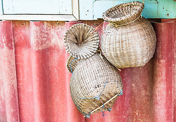 Image showing Handmade wicker baskets for fish hanging on wall 