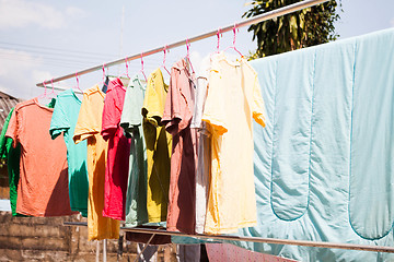 Image showing Dry clothes in the air with sun light