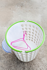 Image showing Cloth hanger and wash bag in plastic laundry basket  