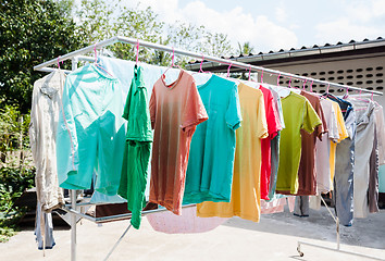 Image showing Laundry hanging out to dry outdoors in summer 