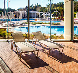 Image showing Sunbeds in the indoor swimming pool