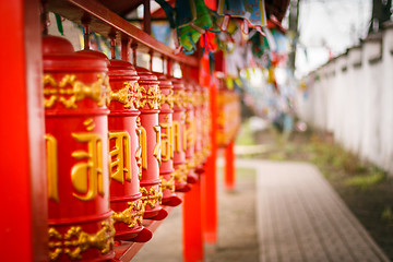 Image showing Line of red praying drums at datsan