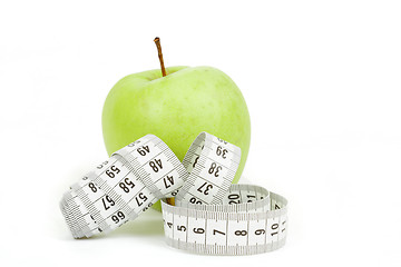 Image showing Measuring tape and green apples as a symbol of diet