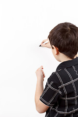 Image showing young boy student in a writing on a whiteboard