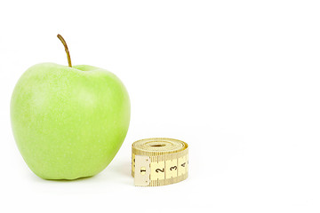 Image showing Green apple and measuring tape isolated on white background