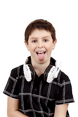 Image showing Young boy grinning and show tongue with headphones