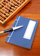 Image showing Chinese book , abacus and writing brush