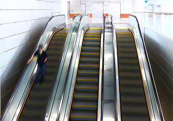 Image showing Blurred person on escalator