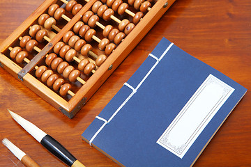 Image showing Chinese book , abacus and writing brush