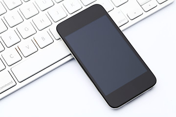 Image showing Smartphone on computer keyboard