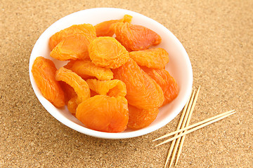 Image showing Dried apricots with toothpick 