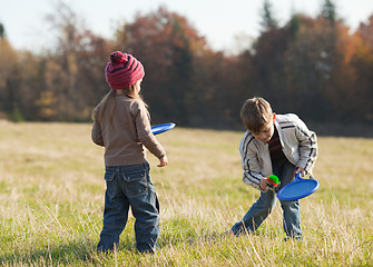 Image showing Kids playing tennis outside