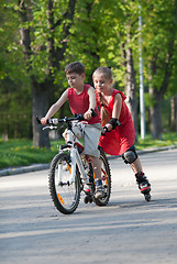 Image showing Cyclist and rollerblader