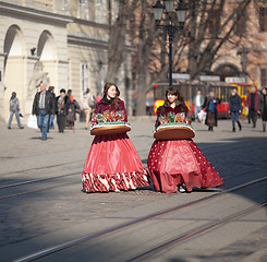 Image showing Young girls sell sweets 
