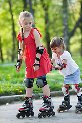 Image showing Sisters skating in park