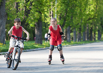 Image showing Cyclist and rollerblader