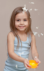 Image showing Girl playing with paper