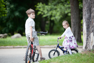 Image showing Siblings riding bicycles