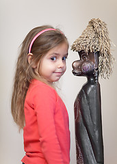 Image showing Little girl with ethnic doll