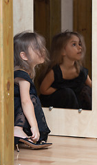 Image showing Little girl reflected in mirror