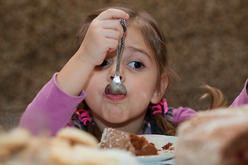 Image showing Little girl eating cake