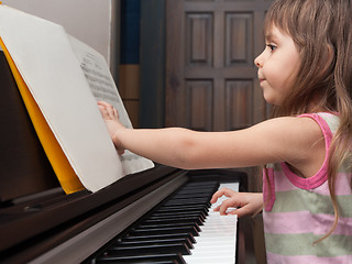 Image showing Little girl playing the piano