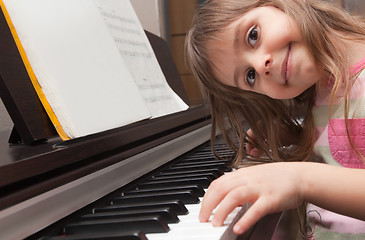 Image showing Little girl playing piano