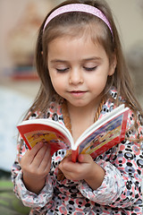 Image showing Girl looking at book