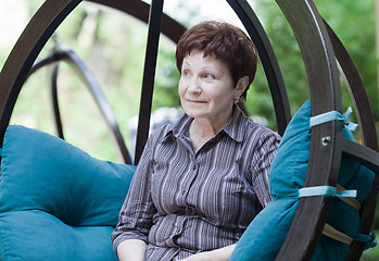 Image showing Woman in wooden swing