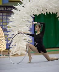 Image showing Gymnast girl doing exercise with hoola hoop