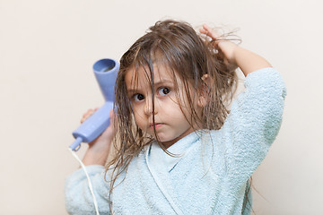 Image showing Little girl drying her hair